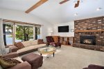 Spacious living room with views of Hutchins Lake, a flat screen TV, and a fireplace available in the off season
